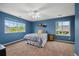 Cozy bedroom features a full-sized bed, ceiling fan, carpet, and bright windows at 5791 Chisholm Pl, Parker, CO 80134