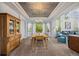 Open dining area with decorative ceiling, natural light, and views of the living room at 5791 Chisholm Pl, Parker, CO 80134