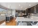 Modern kitchen with dark cabinets, stainless steel appliances, and a large center island at 5791 Chisholm Pl, Parker, CO 80134