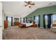 Spacious main bedroom features vaulted ceilings, plush carpet, ensuite bath, and bright windows at 5791 Chisholm Pl, Parker, CO 80134