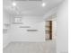 The unfinished basement with gray carpet, white walls and track lighting is ready for your personal touch at 9453 W Utah Pl, Lakewood, CO 80232