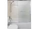Bathroom featuring tiled shower-tub combo with sliding doors and showerhead faucet at 9453 W Utah Pl, Lakewood, CO 80232