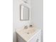 Bright bathroom features a decorative mirror above a vanity with neutral countertop and faucet at 9453 W Utah Pl, Lakewood, CO 80232