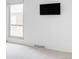 Bright bedroom with neutral carpet, large window, and TV mounted on the wall at 9453 W Utah Pl, Lakewood, CO 80232