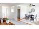Open-concept dining area with hardwood floors, a modern light fixture, and contemporary furniture at 9453 W Utah Pl, Lakewood, CO 80232
