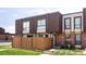 Charming townhome featuring a well-manicured lawn and tasteful brick and siding facade at 9453 W Utah Pl, Lakewood, CO 80232