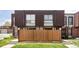 Townhome exterior with a privacy fence and lush lawn in front, providing a cozy and inviting curb appeal at 9453 W Utah Pl, Lakewood, CO 80232