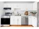Modern kitchen with white cabinets, stainless steel appliances, and marble countertops for a sleek, clean look at 9453 W Utah Pl, Lakewood, CO 80232