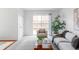 Inviting living room with sliding glass doors to the outdoor patio, neutral tones and modern decor at 9453 W Utah Pl, Lakewood, CO 80232