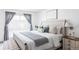 Cozy bedroom featuring a beautifully dressed bed, neutral walls, and soft natural light at 9453 W Utah Pl, Lakewood, CO 80232