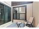 Private patio area featuring a sliding glass door and comfortable chair, ideal for relaxation at 9453 W Utah Pl, Lakewood, CO 80232