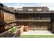 Fenced-in patio featuring a planter and artificial turf perfect for outdoor enjoyment at 9453 W Utah Pl, Lakewood, CO 80232