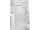 Modern shower with glass door, brushed nickel fixtures, and built-in grab bar at 9453 W Utah Pl, Lakewood, CO 80232