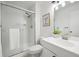 Bathroom featuring white tiling, vanity, faucet, toilet, and shower with glass door at 15942 E Rice Pl # B, Aurora, CO 80015