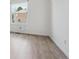 Bedroom with window providing natural light and wood-look floors at 15942 E Rice Pl # B, Aurora, CO 80015