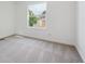 Bright bedroom with large window providing natural light, and neutral carpet at 15942 E Rice Pl # B, Aurora, CO 80015