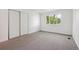 Bright bedroom featuring a window, closet, and neutral colored walls and carpet at 15942 E Rice Pl # B, Aurora, CO 80015