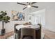 Bright dining area featuring a ceiling fan, modern art, and comfortable seating at 15942 E Rice Pl # B, Aurora, CO 80015
