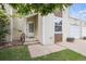 Cozy home entrance featuring white door with sidelight and lush green lawn at 15942 E Rice Pl # B, Aurora, CO 80015
