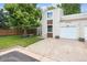 Charming exterior view of home with attached garage, green lawn, and mature shade tree at 15942 E Rice Pl # B, Aurora, CO 80015