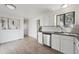 Bright kitchen with stainless steel appliances, white cabinets, and wood-look flooring at 15942 E Rice Pl # B, Aurora, CO 80015