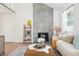 Charming living room with modern decor, large tiled fireplace, and an open floor plan at 15942 E Rice Pl # B, Aurora, CO 80015
