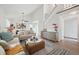 Open living space with white walls, modern decor, and a staircase to the second floor at 15942 E Rice Pl # B, Aurora, CO 80015