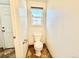 Powder room features a standard toilet and window for natural light at 2247 Coronado Pkwy N #D, Denver, CO 80229