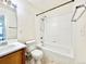 Bathroom with white tiled shower and wood vanity cabinet at 2247 Coronado Pkwy N #D, Denver, CO 80229
