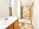 Bathroom featuring a tiled shower, modern vanity, and updated fixtures at 2247 Coronado Pkwy N #D, Denver, CO 80229