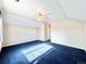 Bright bedroom featuring a fan, plush blue carpets, and ample space at 2247 Coronado Pkwy N #D, Denver, CO 80229