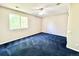 Bright bedroom features large window and ceiling fan with navy blue carpet and neutral walls at 2247 Coronado Pkwy N #D, Denver, CO 80229