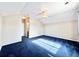 Bedroom with a ceiling fan, plush blue carpet, and an ensuite bathroom at 2247 Coronado Pkwy N #D, Denver, CO 80229