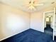This neutral bedroom with blue carpet has a ceiling fan and a bright and airy feel at 2247 Coronado Pkwy N #D, Denver, CO 80229