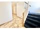 Welcoming entryway featuring neutral tile flooring and staircase leading to the upper level, offering a bright and open feel at 2247 Coronado Pkwy N #D, Denver, CO 80229
