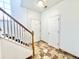 Bright entryway with tile flooring, carpeted stairs, and ample lighting, providing a clean and inviting first impression at 2247 Coronado Pkwy N #D, Denver, CO 80229