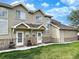 Inviting townhome with stone accents, multiple windows, and a well-kept lawn, creating a charming and attractive exterior at 2247 Coronado Pkwy N #D, Denver, CO 80229