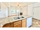 Open kitchen with granite countertops seamlessly connects to the living area, which features a cozy fireplace and backyard access at 2247 Coronado Pkwy N #D, Denver, CO 80229