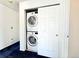 Stackable washer and dryer tucked away in closet, saving space at 2247 Coronado Pkwy N #D, Denver, CO 80229