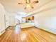 Bright living room with hardwood floors leading to an open kitchen and staircase at 2247 Coronado Pkwy N #D, Denver, CO 80229