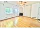 Bright living room with hardwood floors, a fireplace, and a large window offering natural light and backyard access at 2247 Coronado Pkwy N #D, Denver, CO 80229