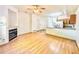 Open-concept living room featuring a fireplace, hardwood floors, and a view of the kitchen with granite countertops at 2247 Coronado Pkwy N #D, Denver, CO 80229
