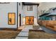 This backyard features a patio with an outdoor seating area and a modern exterior with black trim windows at 4139 Benton Street, Denver, CO 80212