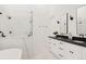 Sleek bathroom featuring double vanities, modern fixtures, and a glass-enclosed shower at 4139 Benton Street, Denver, CO 80212