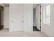 Neutral bedroom with new carpeting, closets, and a doorway to the bathroom at 4139 Benton Street, Denver, CO 80212