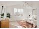 Bright bedroom featuring a large window, minimalist decor, and a patterned rug at 4139 Benton Street, Denver, CO 80212