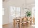 Bright dining room with light wood table, natural light, and minimalist chandelier at 4139 Benton Street, Denver, CO 80212