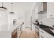Bright, modern kitchen with white cabinets, a large island and stainless steel appliances at 4139 Benton Street, Denver, CO 80212