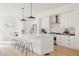 Beautiful kitchen with white cabinetry, large center island, and pendant lighting at 4139 Benton Street, Denver, CO 80212