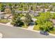 Aerial view of a well-landscaped home with mature trees and a long driveway at 13133 Regulus Dr, Lone Tree, CO 80124